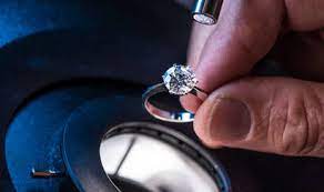 Jeweler looking at ring through a loupe